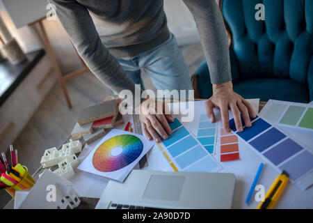 Interior designer looking at color palette while choosing color Stock Photo