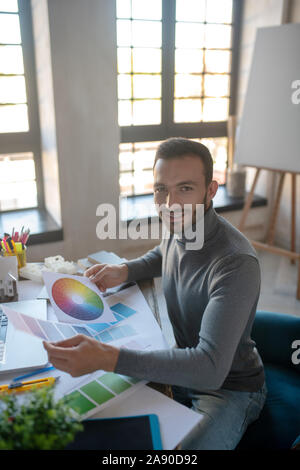 Smiling interior designer feeling good while working Stock Photo