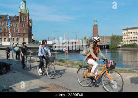 Cycling city Scandinavia, view in summer of a group of cyclists riding their bikes on a cycle lane in the center of Stockholm, Sweden. Stock Photo