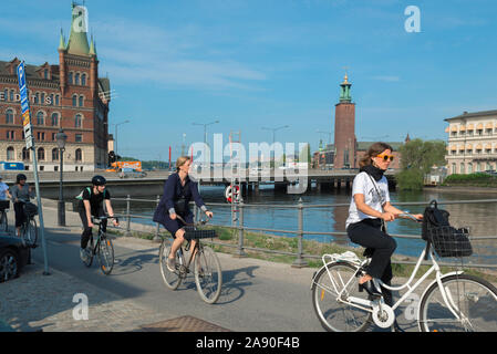 Cycling Scandinavia city, view in summer of a group of young people riding their bikes on a cycle lane in the center of Stockholm, Sweden. Stock Photo