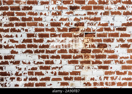 Background of old grunge brick wall texture with peeling plaster. Stock Photo