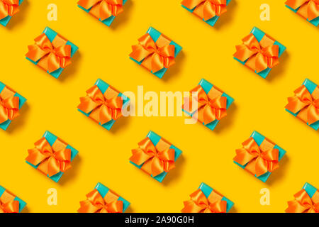 Pattern with stylish gift on a trendy orange background. Present for St. Valentine's day, engagements, Mother's Day, birthday, New Year, Christmas, holidays Stock Photo