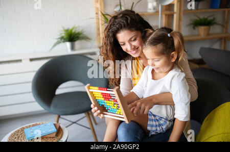 Happy loving family. Beautiful mother and child girl playing, kissing and hugging Stock Photo