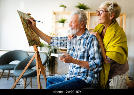 Handsome senior man and attractive old woman are enjoying spending time together Stock Photo
