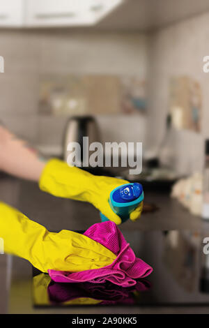 woman wiping dust using a duster Stock Photo - Alamy