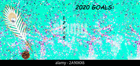 2020 goals. Christmas festive decorations, golden feather, colorful confetti, cone and wish list on green mint trendy background , flat lay style Stock Photo