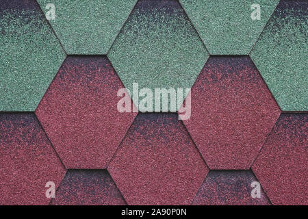 Red and green surface of roofing tiles. Cover of shape of rhombus. Dark roof tile, grunge background. Abstract mosaic of bricks background. Grunge wal Stock Photo