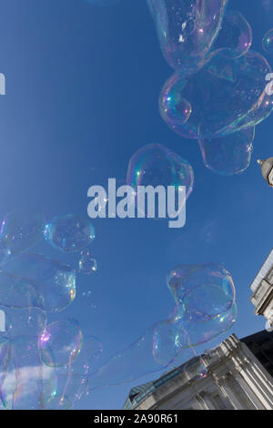 Bubbles created by a busker / street performer , in front of  The National Gallery, Trafalgar Square, London, UK Stock Photo