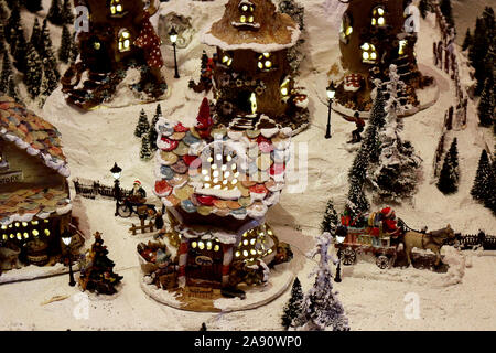 Snowy village diorama decorated with Christmas celebrations Stock Photo