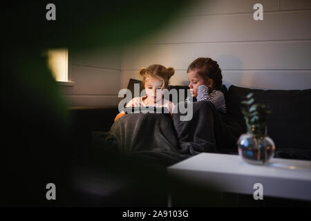 Girls using digital tablet Stock Photo