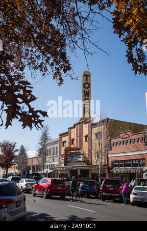 Tree branches hanging over the old Tower Theater on Wall Street in Bend, Oregon, a current music and live theater venue. Stock Photo
