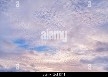 Colored cloudy sky at sunset. Natural texture and background Stock Photo