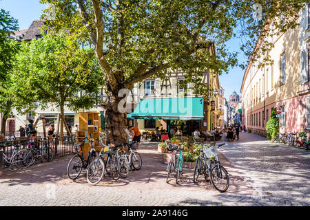 Place des Orphelins and Rue Sainte-Madeleine on a sunny day in the historic district in Strasbourg, France, with Notre-Dame cathedral in the distance. Stock Photo
