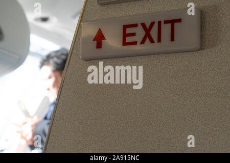 exit sign on airplane detail Stock Photo