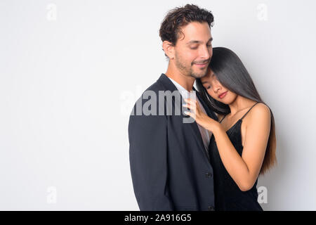 Portrait of multi ethnic business couple hugging each other Stock Photo