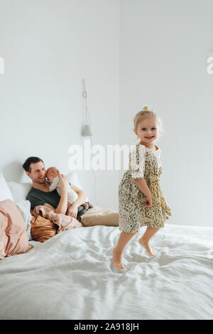 Girl jumping on bed Stock Photo
