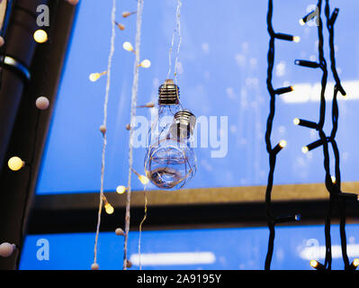 Garlands are hanging on the window. multi-colored light bulbs garlands on a window close-up. New year garland Stock Photo