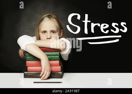 Sad Tired child with books. Stress concept Stock Photo