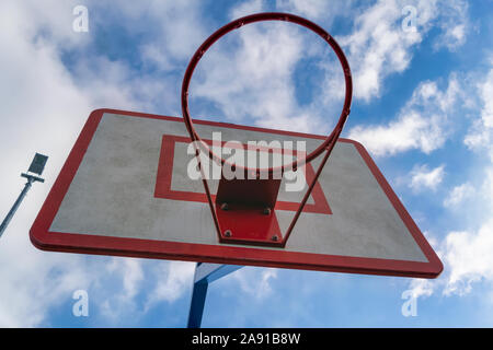 Basketball hoop against blue sky bottom view. Stock Photo