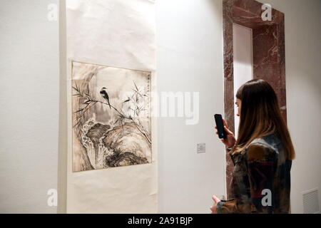 (191112) -- TIRANA, Nov. 12, 2019 (Xinhua) -- A woman visits an exhibition to mark the 70th anniversary of the establishment of diplomatic ties between China and Albania at the Center for Openness and Dialogue (COD) of Albanian Prime Minister's office in Tirana, Albania on Nov. 11, 2019. The exhibition, organized by the COD in cooperation with the Chinese Embassy to Albania, is entitled 'Beyond memories'. The exhibition brought together a collection of commemorative stamps on China issued by the Albanian Post from 1968 to 2009, as well as Chinese traditional artworks from the city of Nanjing. Stock Photo