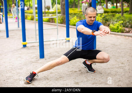 Man doing stretching after hard outdoor workout Stock Photo