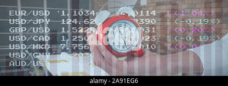 Composite image of cropped hand holding alarm clock Stock Photo