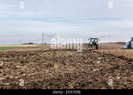 Wheel tractor with multi-plow. Plowing the land in late autumn. Podlasie, Poland. Stock Photo