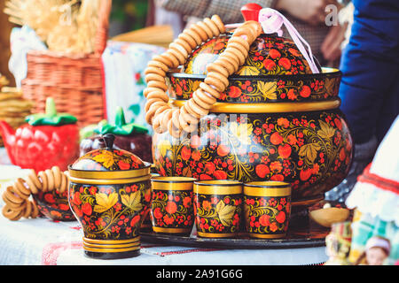 Wooden pan with bagels next to the glasses on the counter at Shrovetide Stock Photo