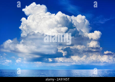 White cumulus clouds over sea close up blue sky background landscape, big fluffy cloud above ocean water panorama, cloudy weather seascape, cloudscape Stock Photo