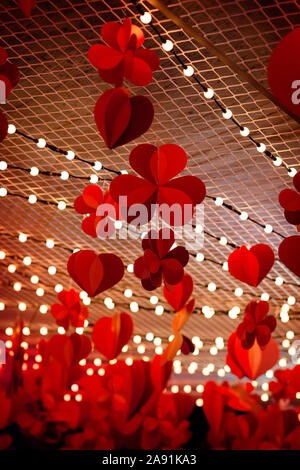 Red paper heart hanging on white background Stock Photo - Alamy
