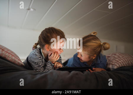 Sisters using digital tablet Stock Photo
