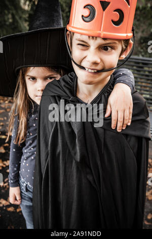 Brother and sister being silly and getting ready to go out for Halloween. Stock Photo