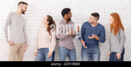 Cheerful friends talking, having break at college Stock Photo