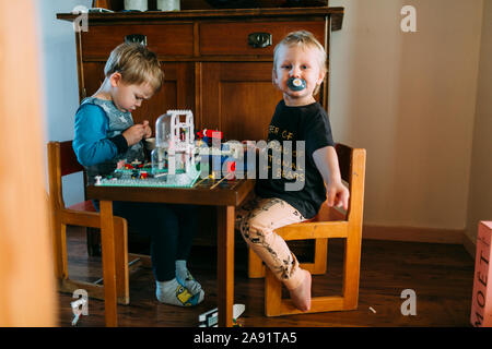 Brothers playing with Lego Stock Photo
