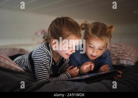 Sisters using digital tablet Stock Photo