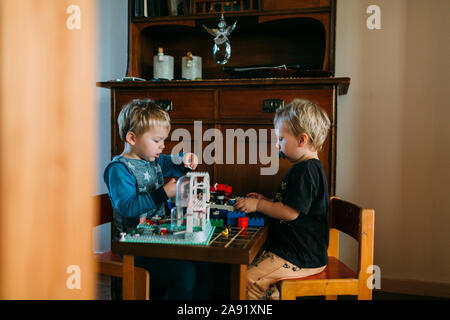 Brothers playing with Lego Stock Photo
