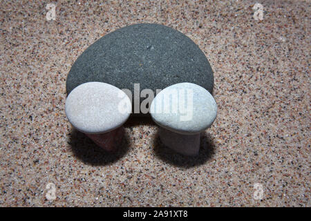 Pebbles on sand Stock Photo