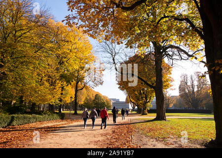 BRUSSELS, BELGIUM, November 10 2019: Sunny autumn morning in Cinquantenaire park with people strolling on alleys. Stock Photo