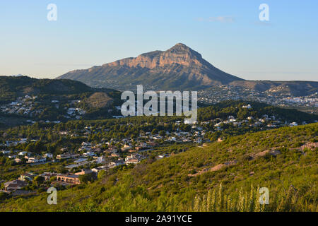 View to Montgo mountain from Granadella Natural Park over countryside, hillside and residential villas. Stock Photo