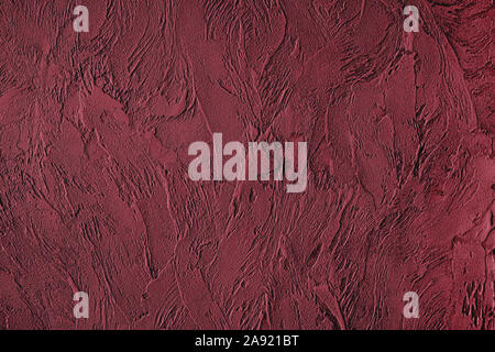 Dark red colored low contrast Concrete textured background with roughness and irregularities to your design or product. Color trend concept. Stock Photo