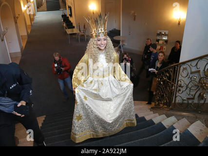 Nuremberg, Germany. 12th Nov, 2019. Benigna Munsi, the new Nuremberg Christkind, goes up a staircase in her robe at the Staatstheater Nürnberg during the official costume rehearsal. The 17-year-old was chosen as the Christ Child for the next two years and will traditionally open the Nuremberg Christkindlesmarkt on 29 November. Credit: Daniel Karmann/dpa/Alamy Live News Stock Photo