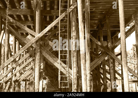 Ancient timbers and ladder under pier at marina on the Campbell River, Vancouver, British Columbia, Canada, 2016 Stock Photo