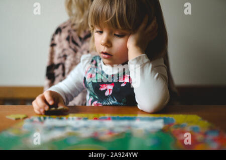 Girl doing puzzles Stock Photo