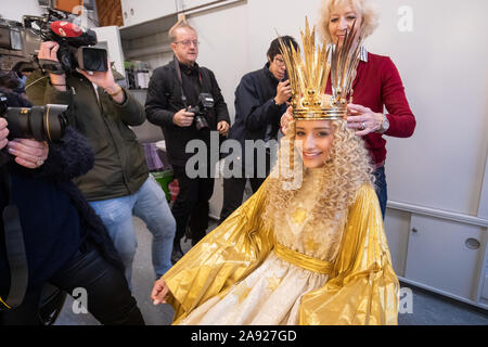 Nuremberg, Germany. 12th Nov, 2019. Benigna Munsi (v), the new Nuremberg Christkind, gets the wig put on by Helke Hadlich, head make-up artist at the Staatstheater Nürnberg, during the official costume rehearsal in the mask. The 17-year-old was chosen as the Christ Child for the next two years and will traditionally open the Nuremberg Christkindlesmarkt on 29 November. Credit: Daniel Karmann/dpa/Alamy Live News Stock Photo