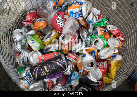 Crushed aluminium drinks cans in a recycling basket Stock Photo