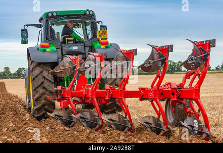 British National Ploughing Championships, Lincoln, UK.  A modern reversable plough used to give demonstrations at the championships Stock Photo