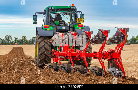 British National Ploughing Championships, Lincoln, UK.  A modern reversable plough used to give demonstrations at the championships Stock Photo