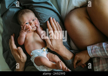 Baby on fathers laps Stock Photo