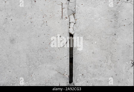 Texture of old concrete wall for background. White concrete wall background with a cracks nad holes. Stock Photo