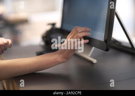 Female hand when working on the touch screen monitor special equipment Stock Photo